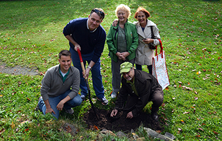 Mayor Mike Savage, Councillor Gloria McCluskey, and Tree Canada's Bruce Carter plant a cherry shrub with Halifax Diverse Program Coordinator, David Foster