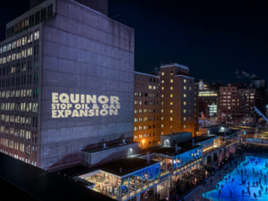 Projection against Equinor's oil and gas projects in Montréal for COP15. Equinor Risks Whales Biodiversity.