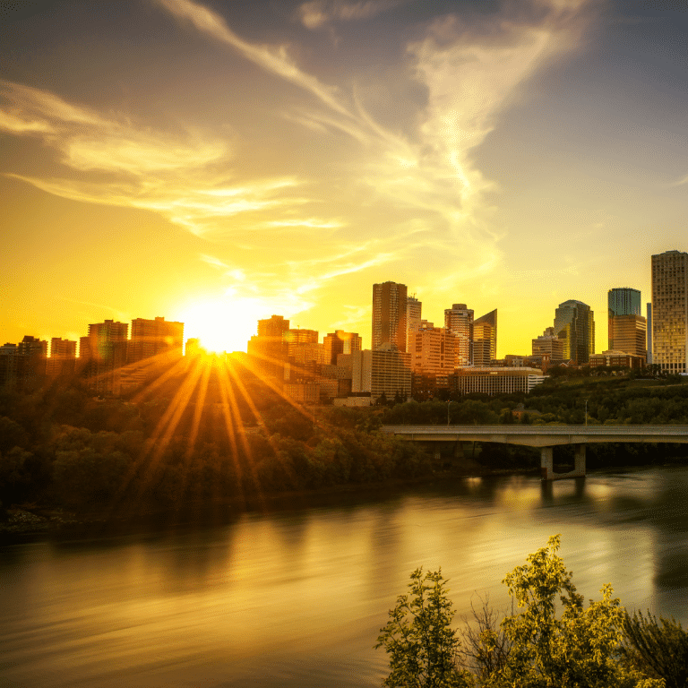 Edmonton with the sun setting behind buildings. Indigenous led walks in Edmonton.