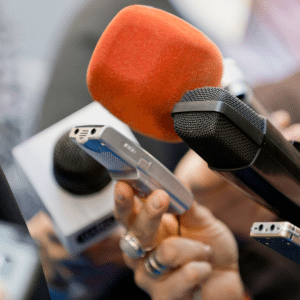 Microphones being held by journalists at a press conference outside. Online News Act. Independent News Canada Bill C18.