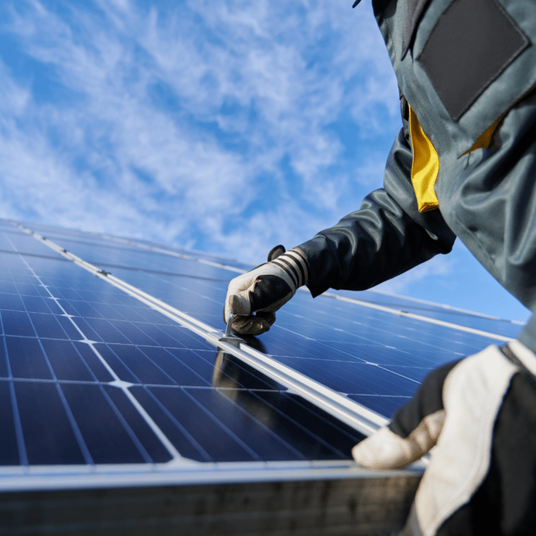 Photo of a solar power worker working on solar panels. From the Community Energy Showcase section, a collaborative project of The Energy Mix and Sierra Club Canada.