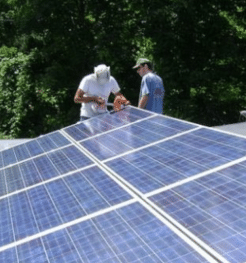 People installing solar panels, part of our support for independent journalism section