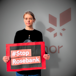 Stine Wilhelmsen holding up a StopRosebank sign. From the page Equinor Rosebank COP28 Podcast