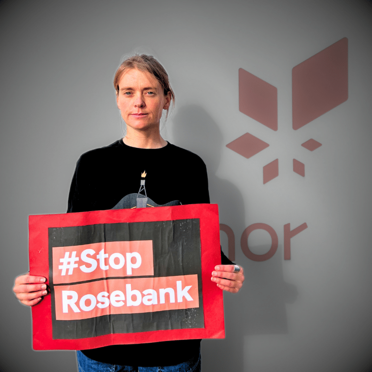 Stine Wilhelmsen holding up a StopRosebank sign. From the page Equinor Rosebank COP28 Podcast.