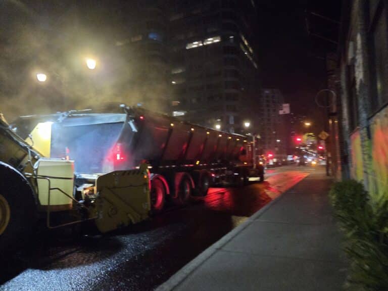 Dark street with asphalt layer in downtown montreal near the co-op bar milton-parc